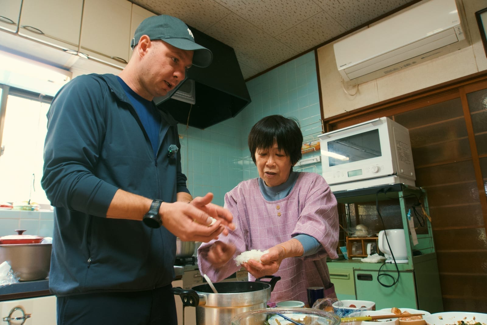 Chef Jason shaping onigiri with a Japanese grandmother