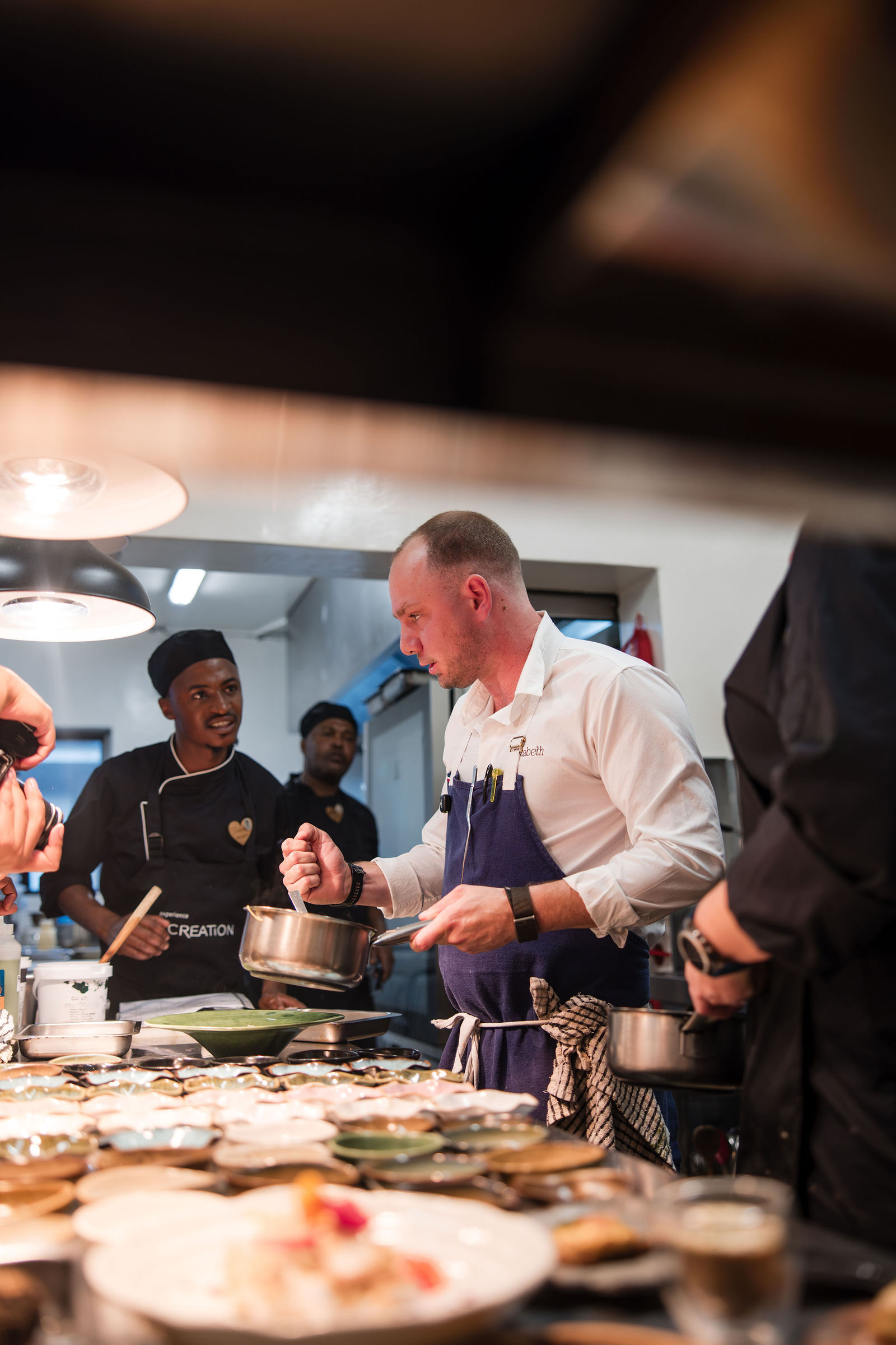 Chef Jason McKinney cooking with the Creation Wines kitchen team
