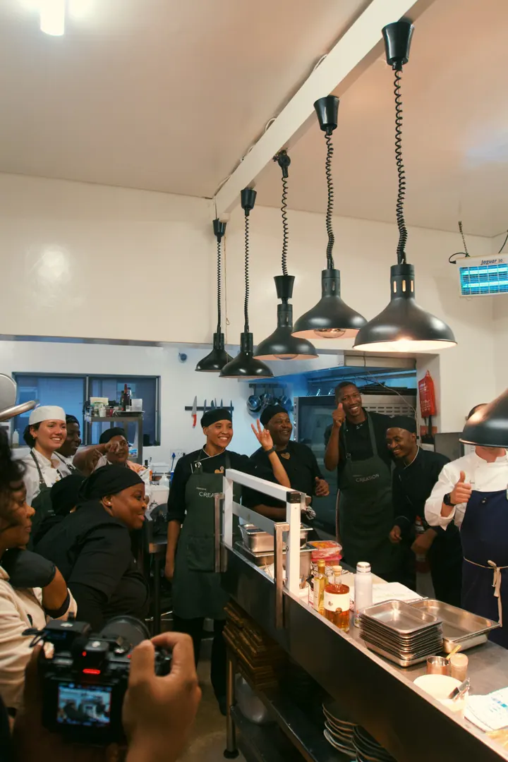 The Creation Wines team and Jason gathered around the kitchen pass