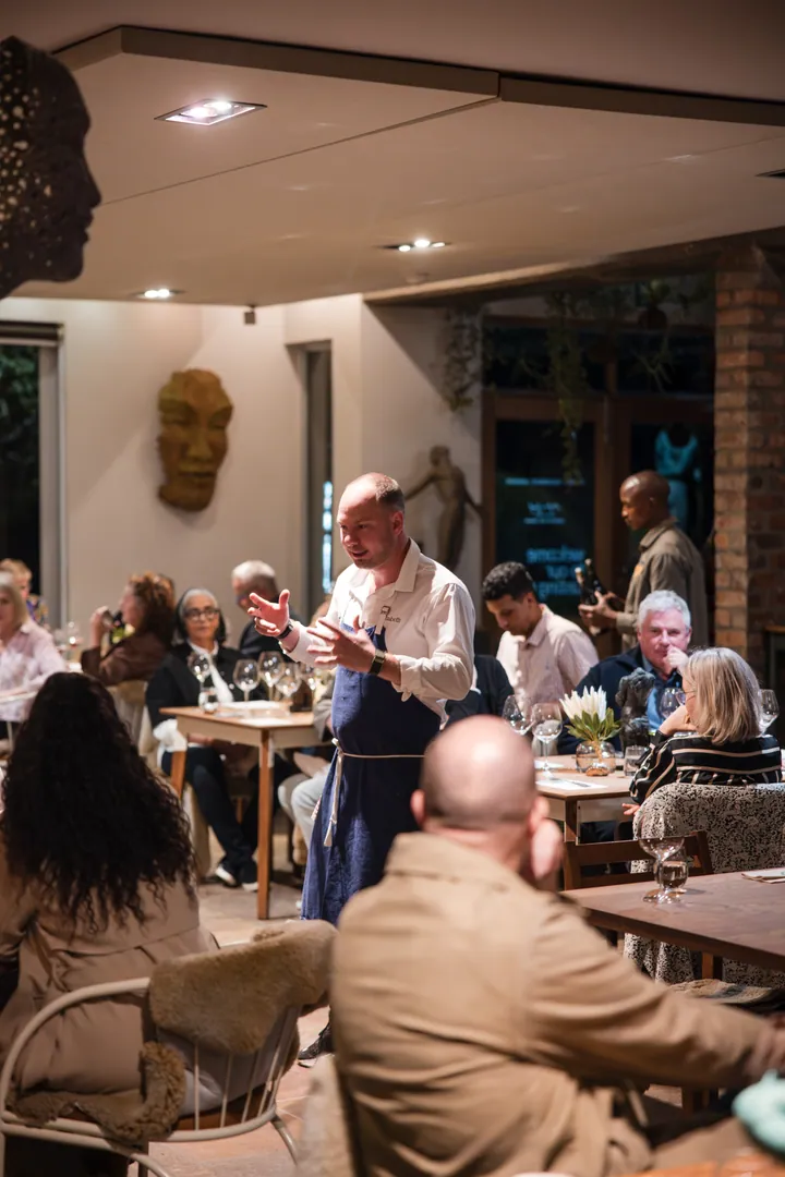 Jason speaking to guests during dinner at Creation Wines