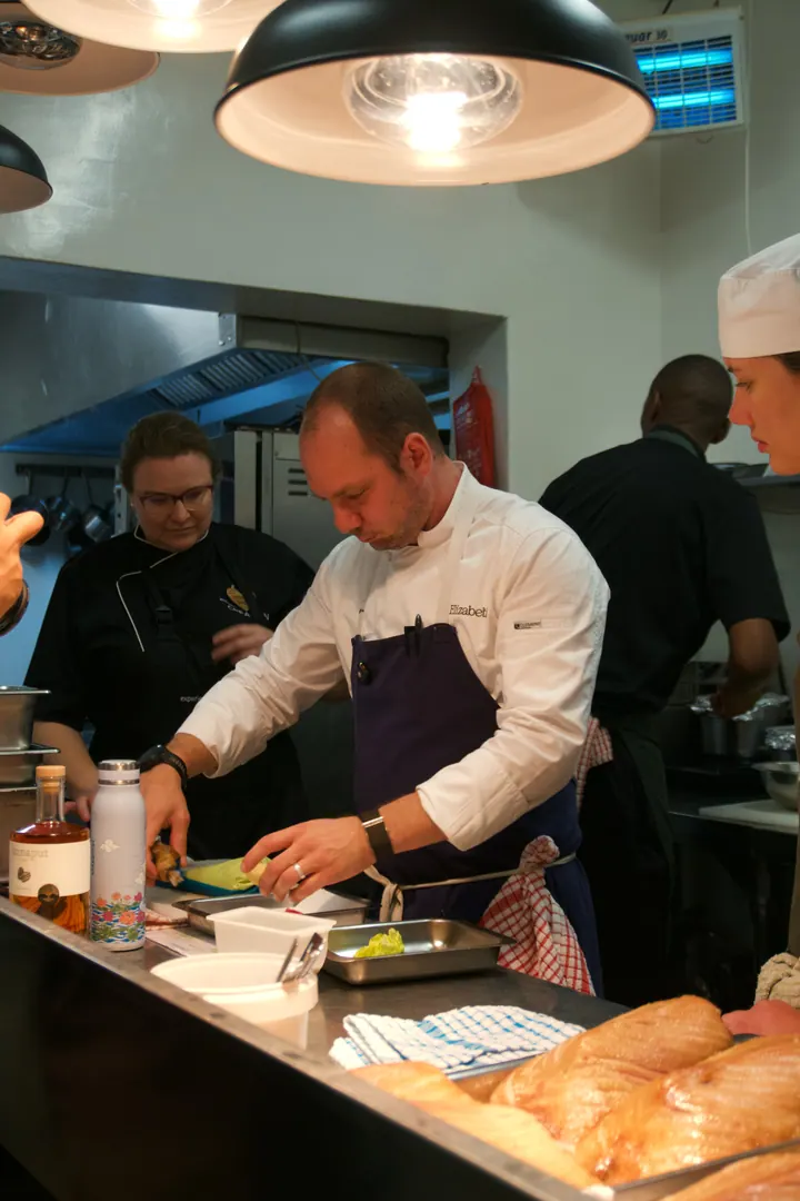 Jason preparing dinner at the pass at Creation Wines
