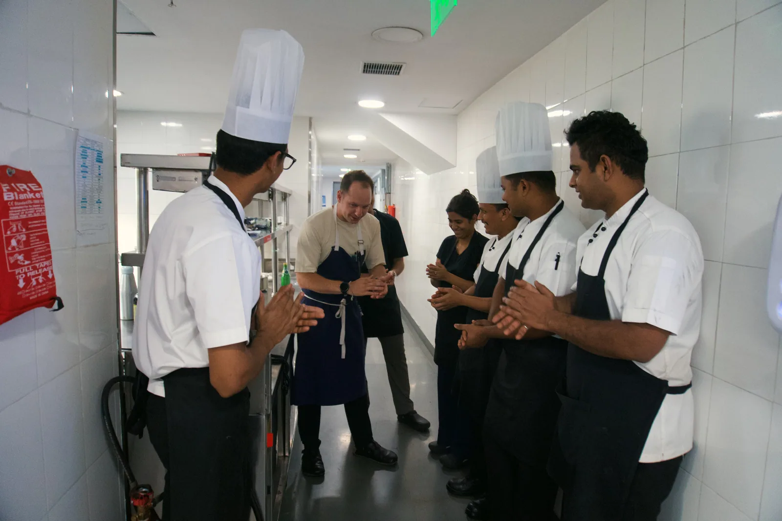 Chef Jason McKinney being welcomed by the kitchen team at The Leela Hyderabad