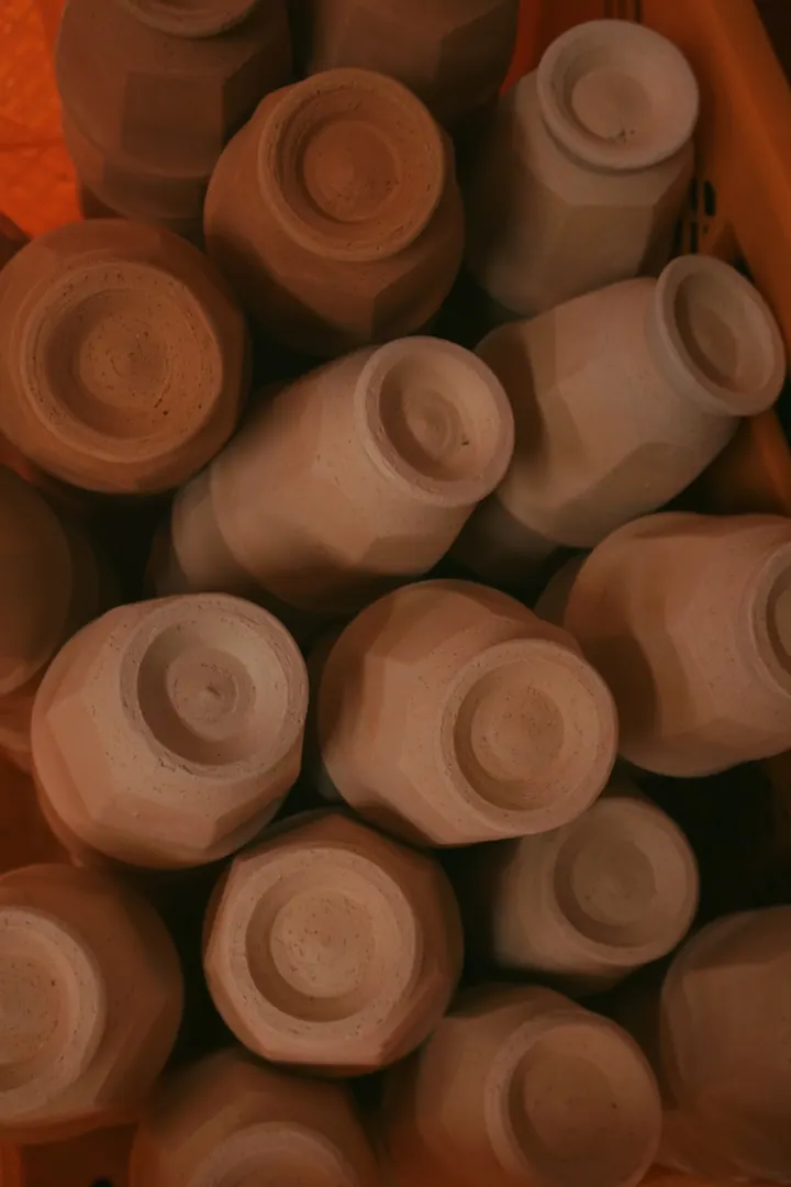 Unglazed clay cups arranged together in a pottery workshop in Yunotsu