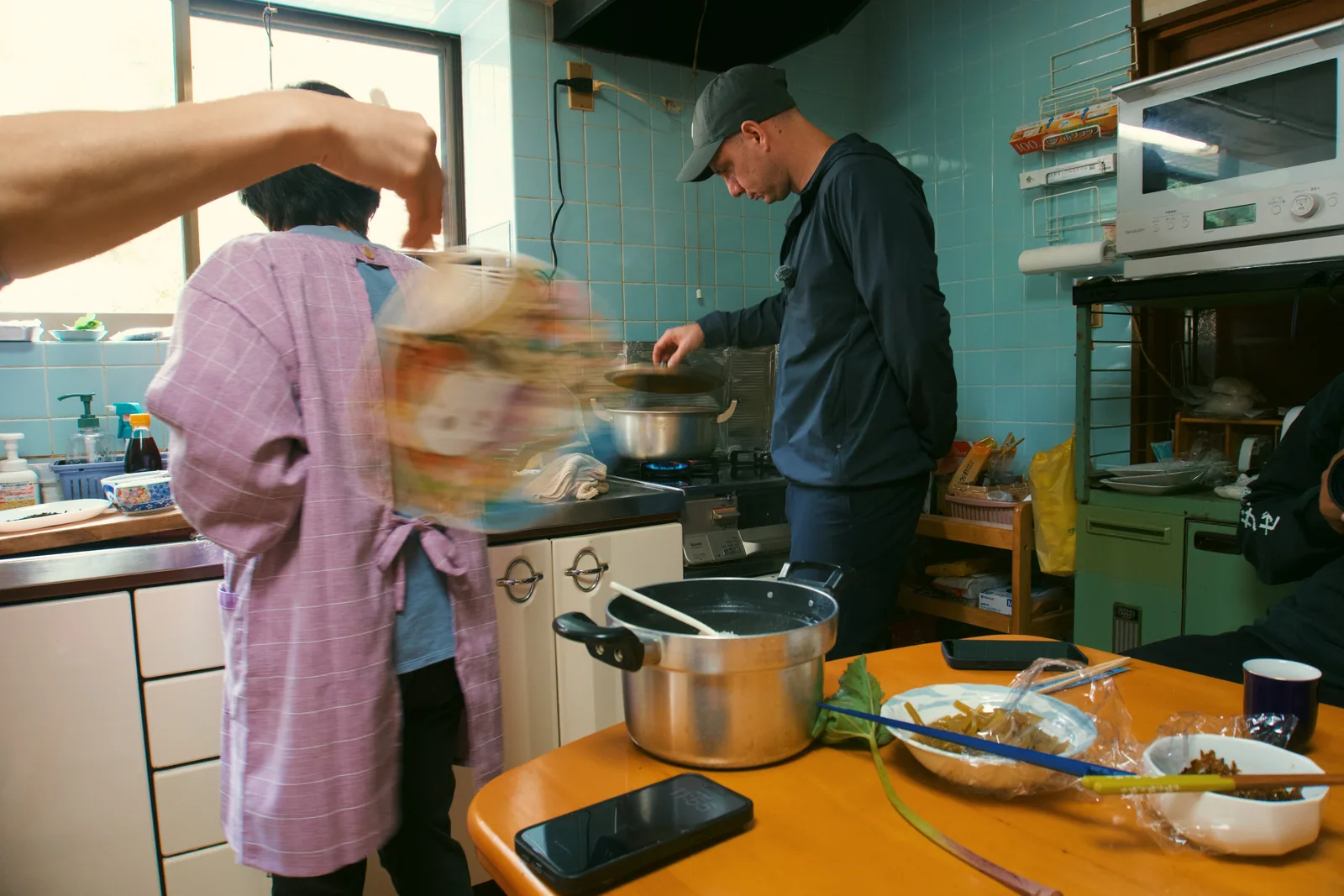 Jason cooking in a small Japanese home kitchen