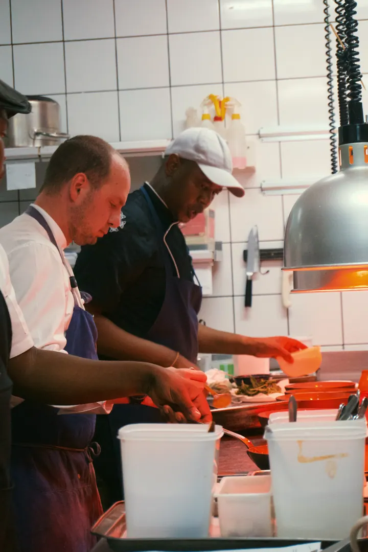Jason preparing food alongside the kitchen team at Kruger Shalati