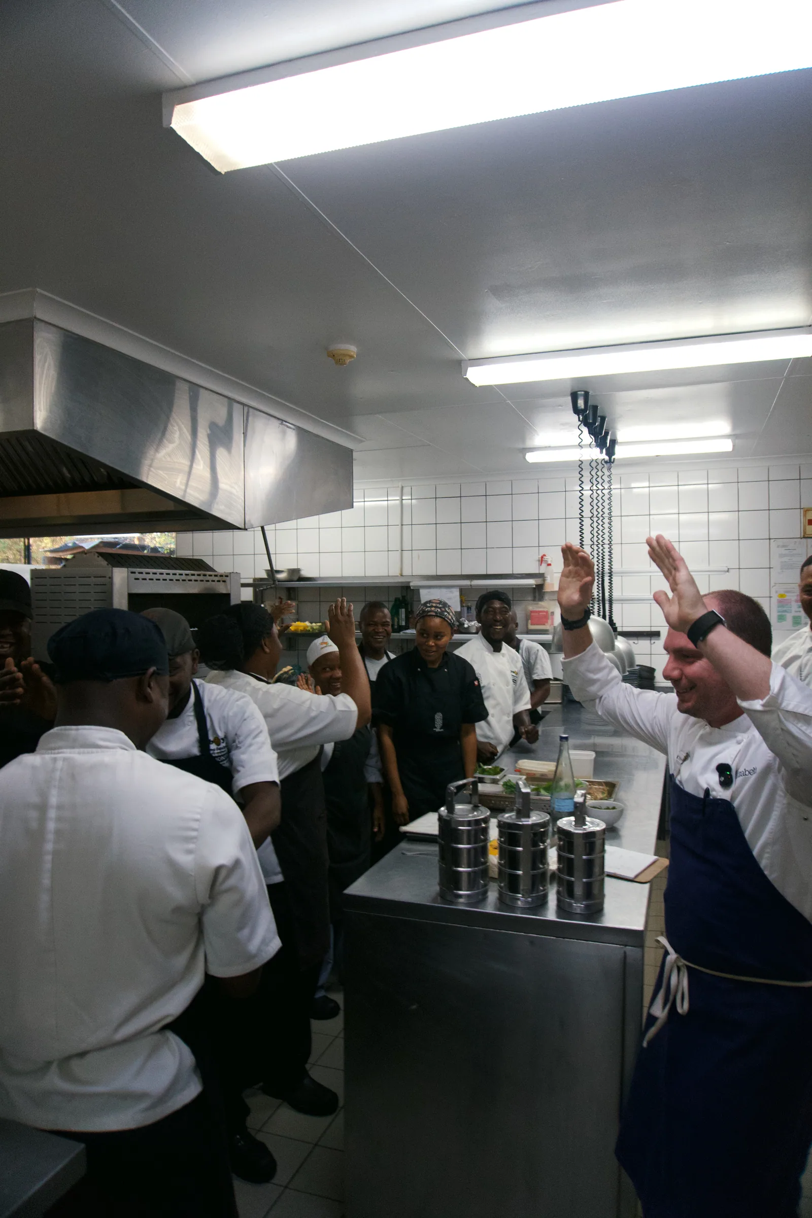Chef Jason McKinney celebrating with the kitchen team at Kruger Shalati