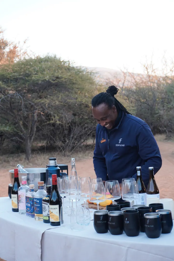 A bartender preparing drinks at an outdoor table at Few & Far