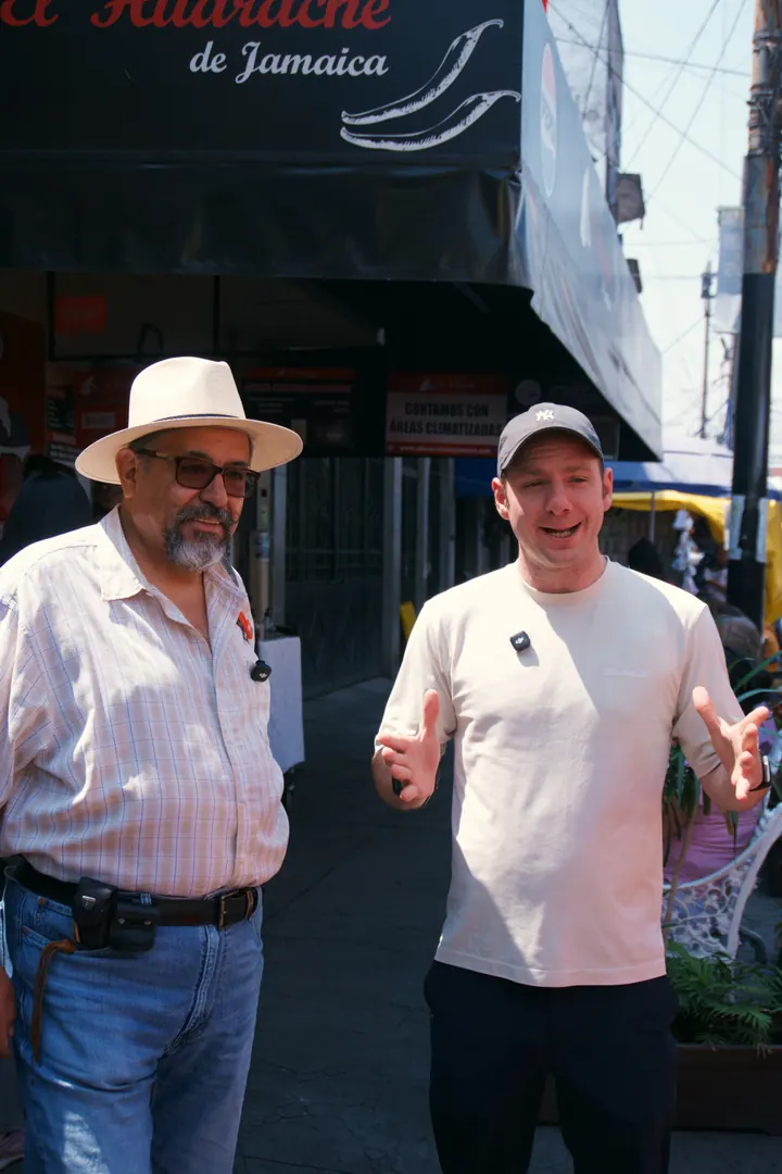 Jason and Paco standing outside a food stop in Mexico City