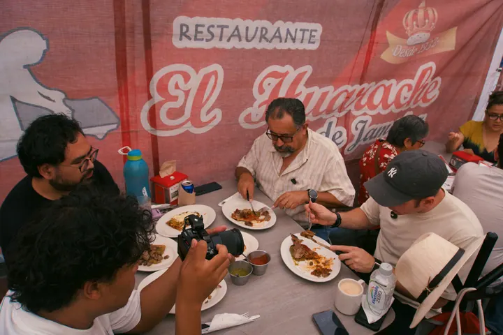 Jason, Paco and Gigi gathered around a table of food during the Mexico City tour