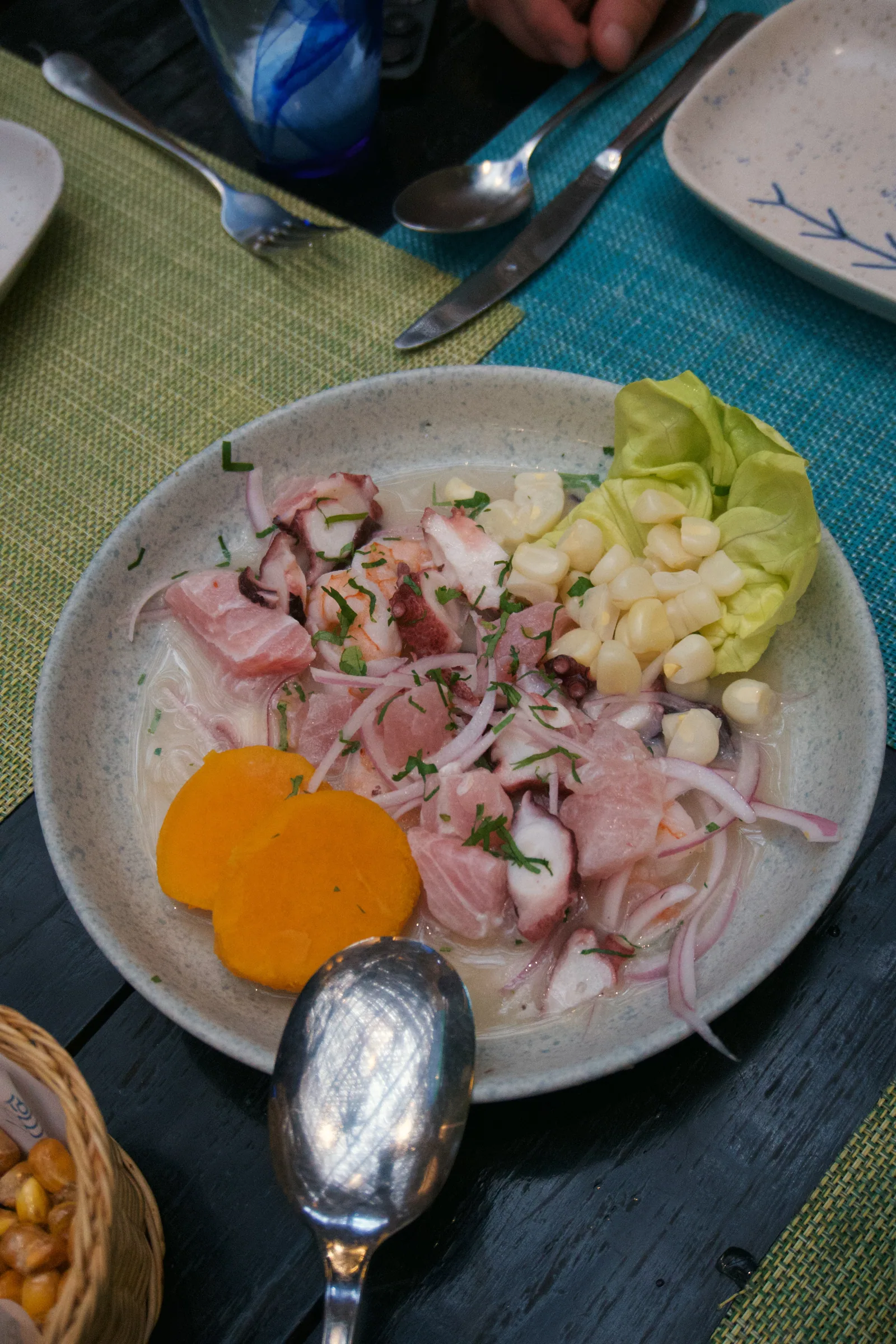 A plate of ceviche with corn and sweet potato in Peru
