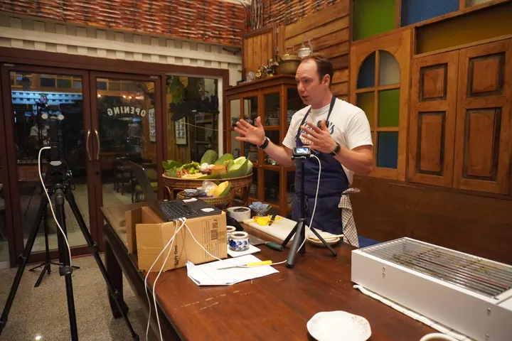 Jason teaching a cooking class from a restaurant in Thailand