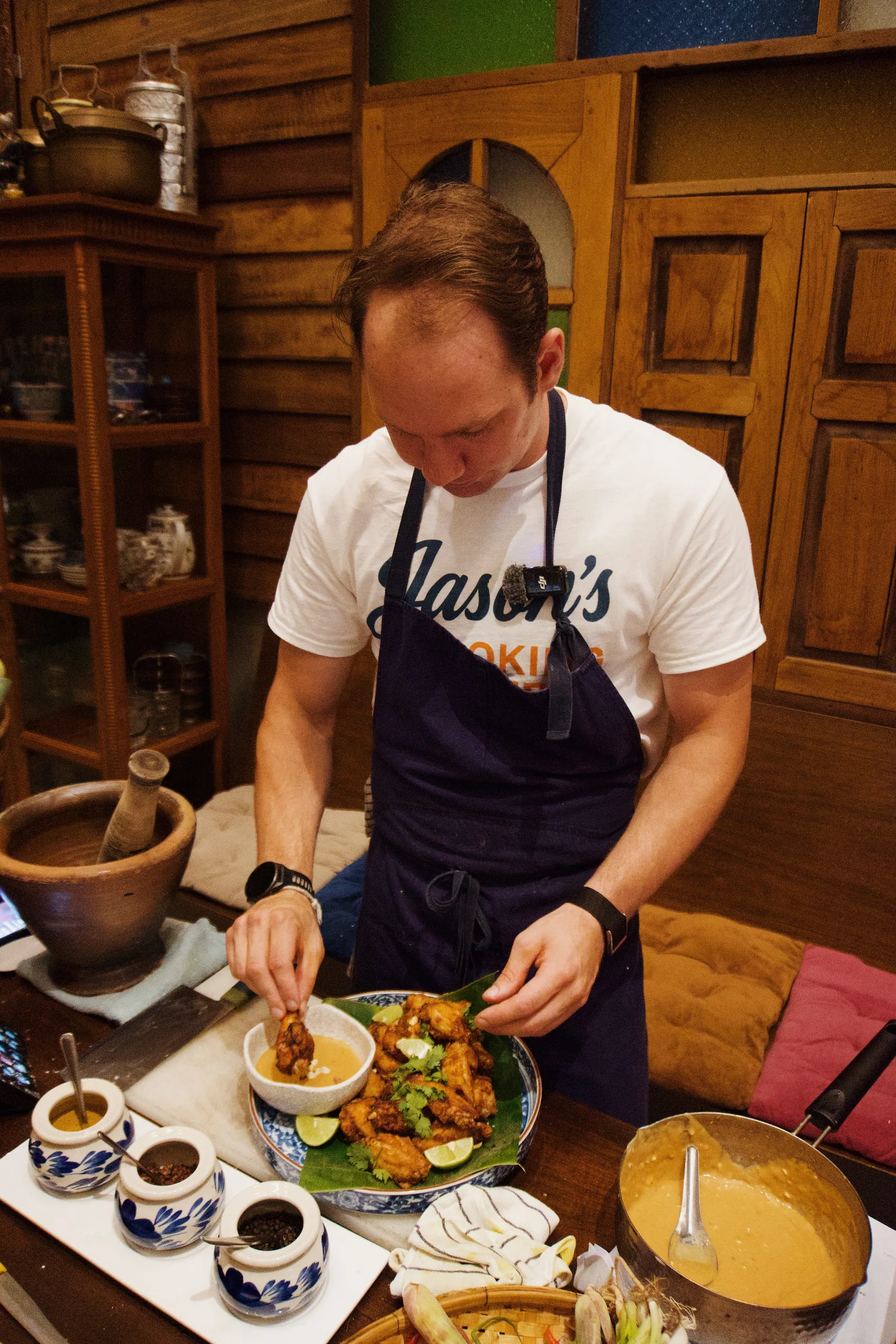 Jason finishing a dish during a cooking session in Thailand